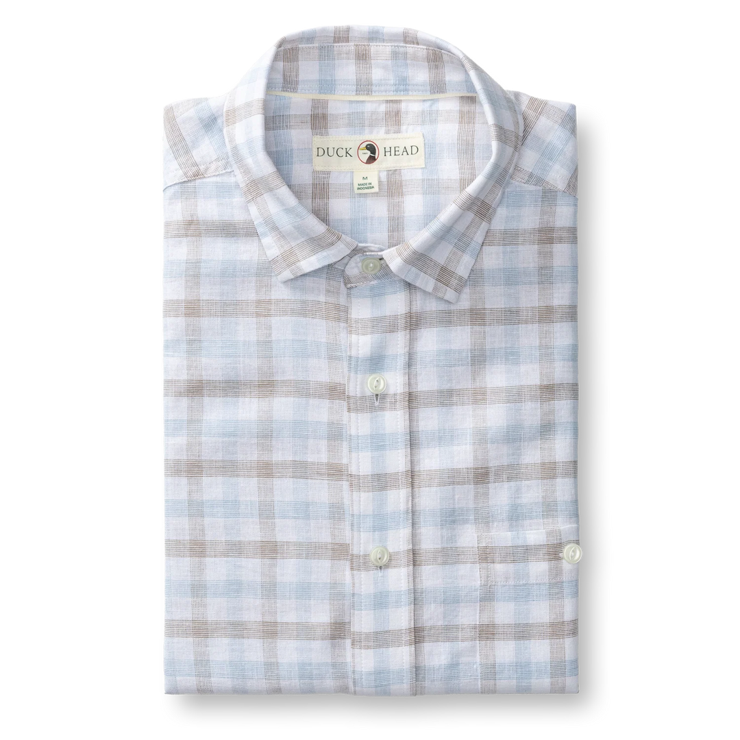 Folded plaid shirt with 'Duck Head' label, polo stripes, with button‑down collar and chest pocket for formal wear or outdoor