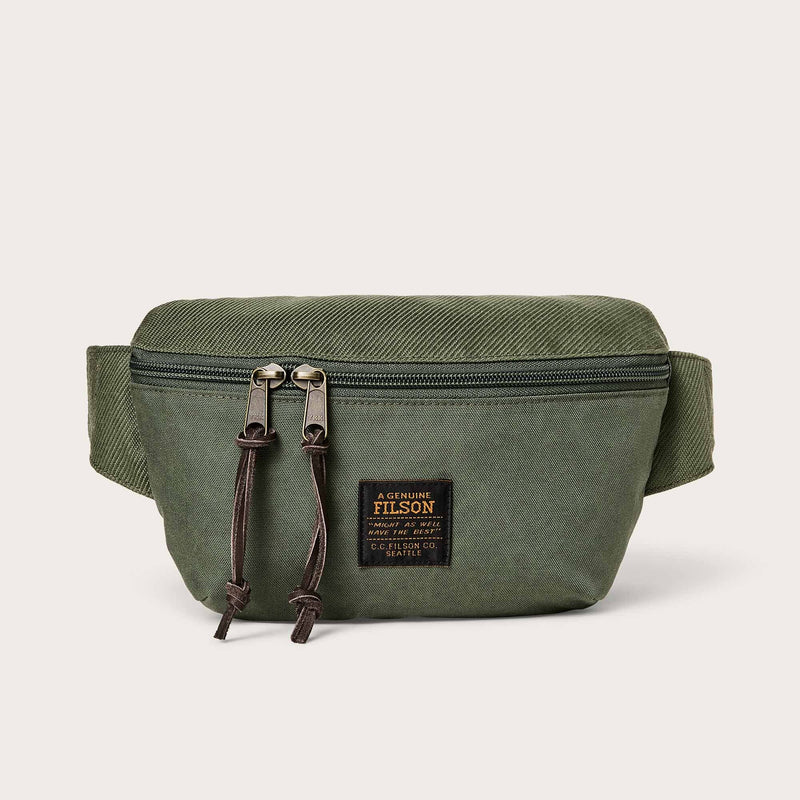 Filson Surveyor Crossbody Pack in green with zippered compartments, durable fabric, and adjustable crossbody strap.