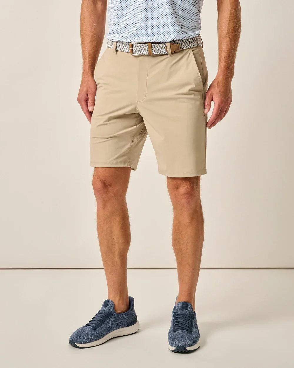 Man wearing Johnnie-O Men Fusion Knit 9 Performance Pull-On Short-Beige