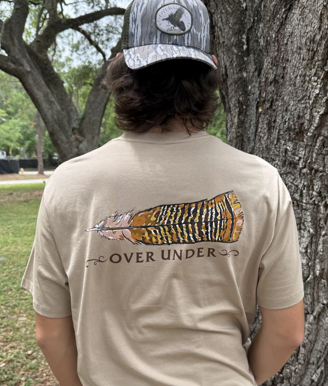 Man wearing Over Under Unisex Final Feather Comfort T-shirt- Beige Back View