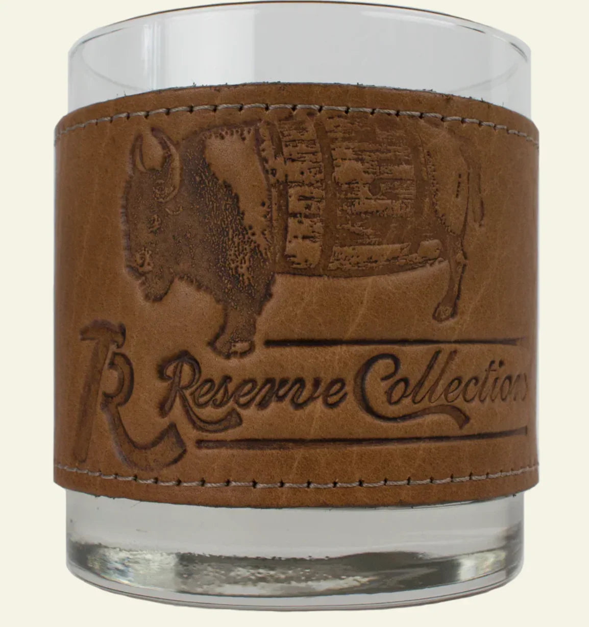 Over Under Bison Wrapped Bourbon Leather Grip Glassware with a brown leather sleeve featuring a buffalo design and 'R&G Reserve Collection' text on a beige background.