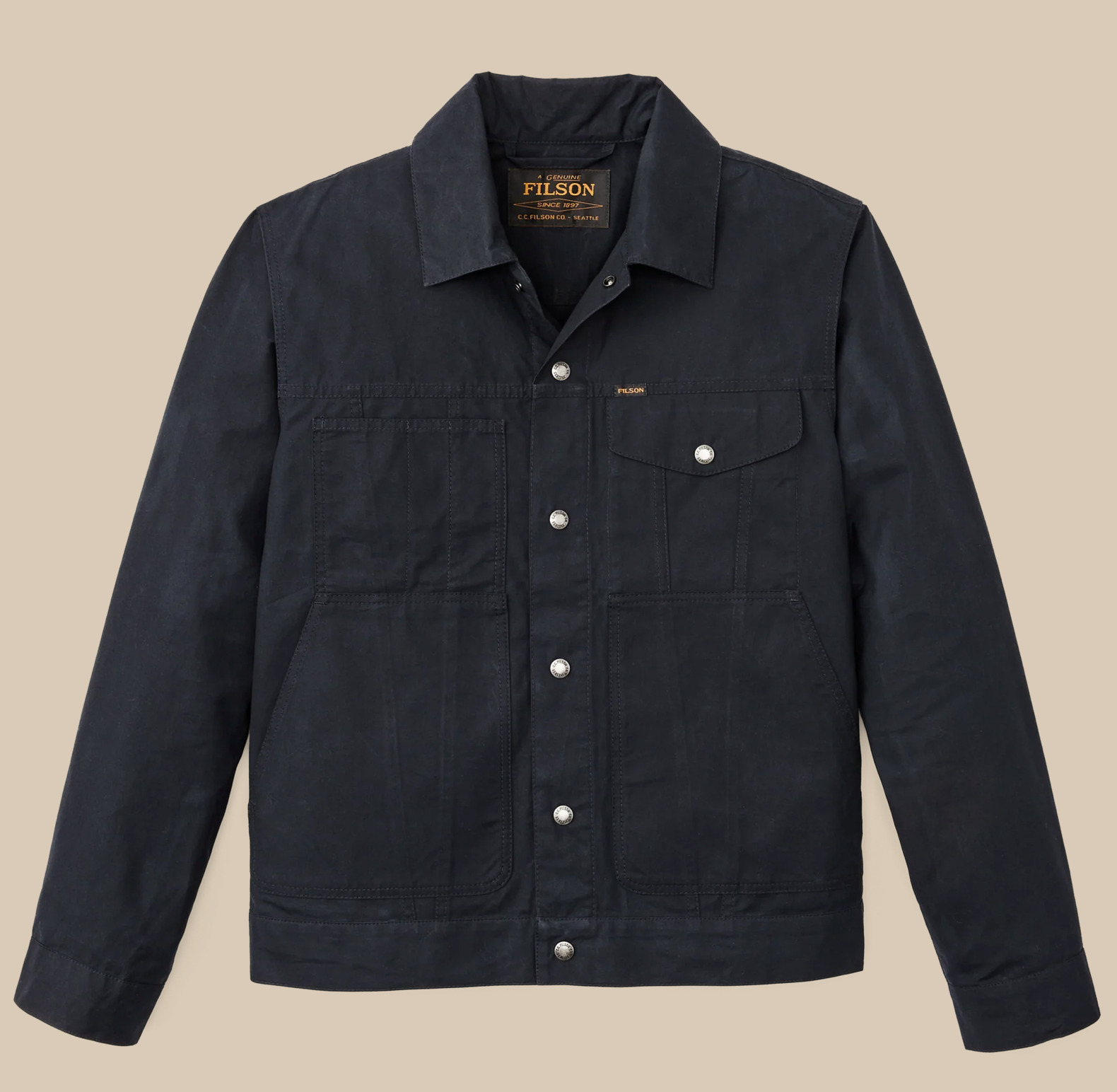 Filson Ranger Cruiser jacket in tan cotton canvas with button‑front closure, chest pockets, and reinforced stitching.