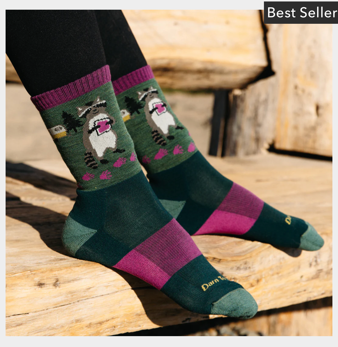 Woman wearing Darn Tough Critter Club Hiking Socks with boots on a trail, showcasing lightweight comfort, seamless fit, and playful outdoor design.