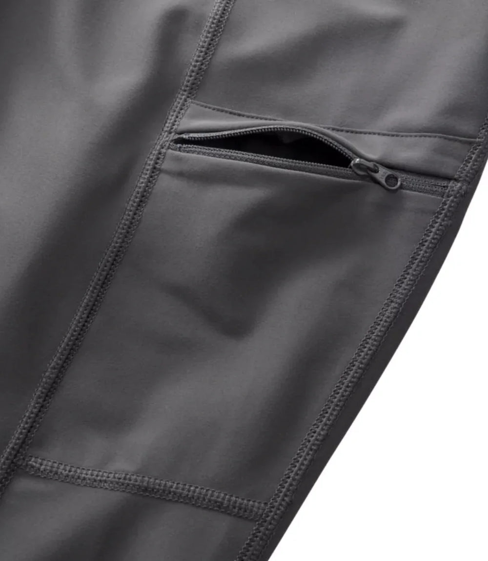 Close-up of a dark gray jacket with a zipper pocket on a white background