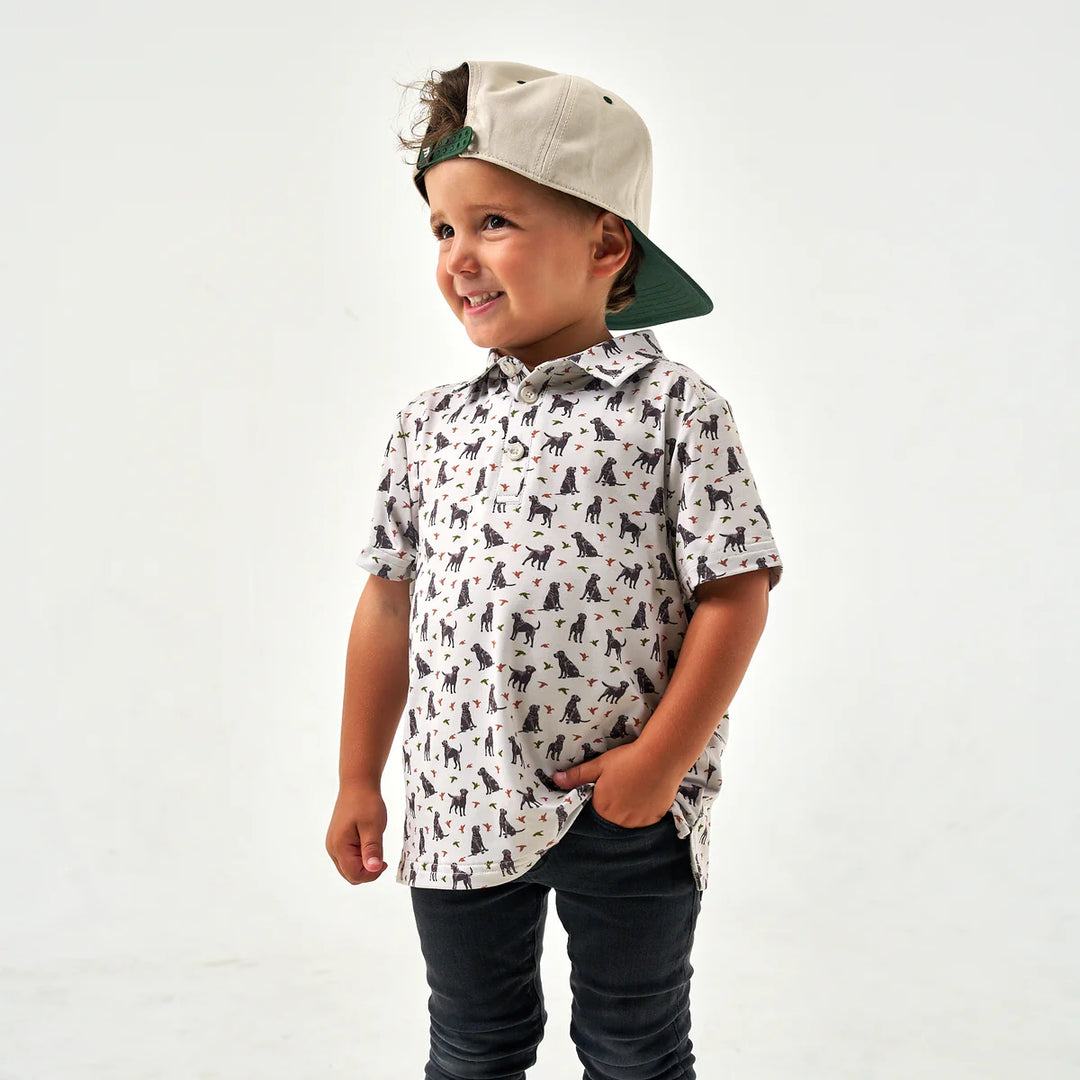 A kid wearing Burlebo Youth Performance Polo outdoors, showcasing lightweight comfort and versatile everyday style.