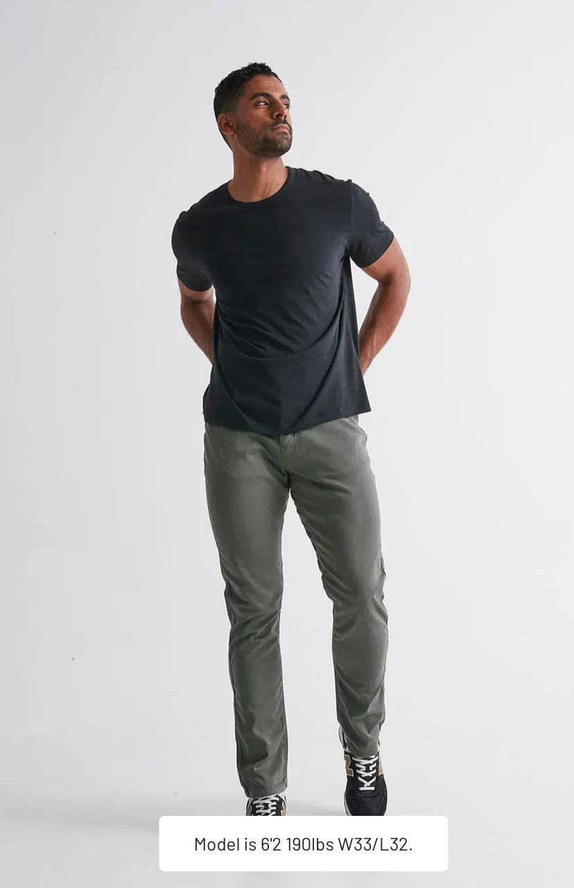 a man wearing DUER No Sweat Performance Comfort Pants - Gray