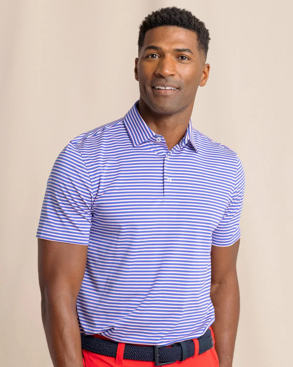 man wearing Southern Tide Classic Activewear Polo Collar Shirt- Blue and White stripes